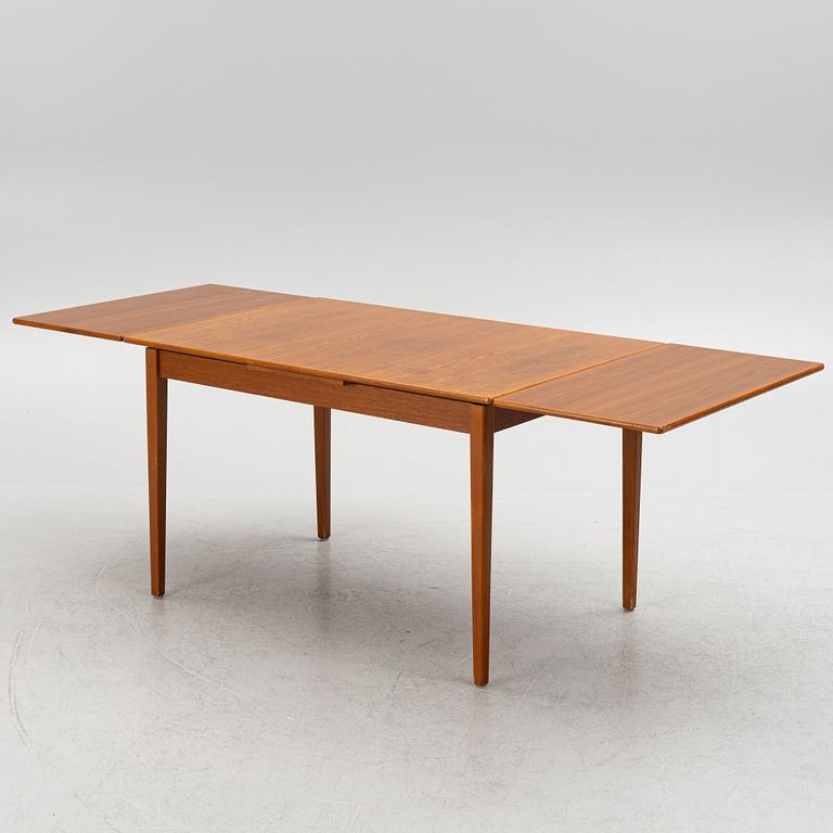 A dining table with four chairs, mid 20th century.