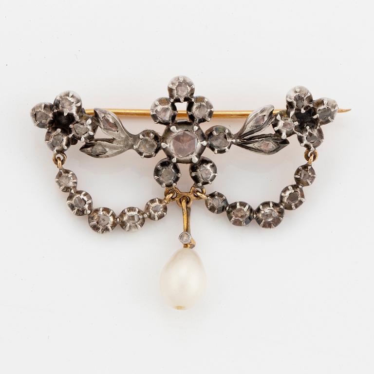 A silver and gold brooch with pearl and rose-cut diamonds.