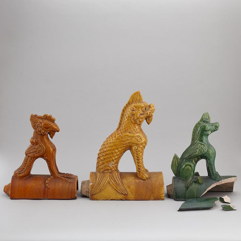 A group of three Chinese glazed roof tiles of seated animals, 20th century.