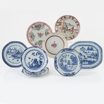 A group of seven Chinese porcelain plates and a charger, 18th / 19th Century.