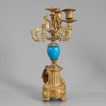 A Louis XVI style mantel clock and a pair of candelabra, circa 1900.