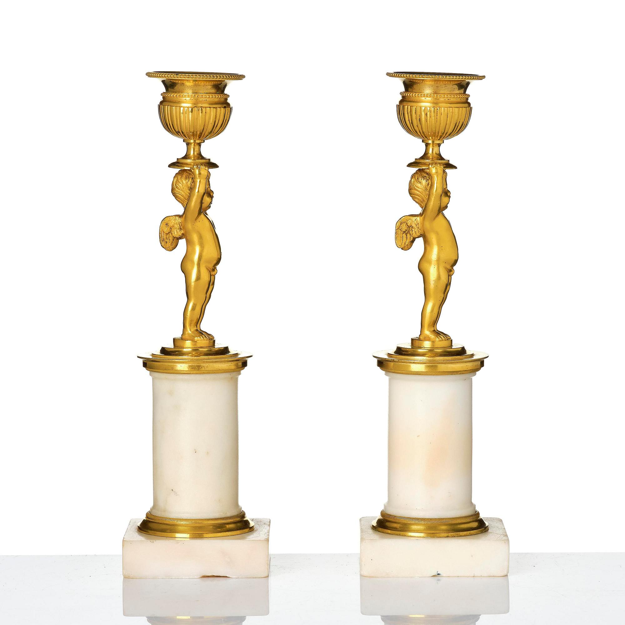 A pair of late Gustavian white marble and ormula candlesticks.
