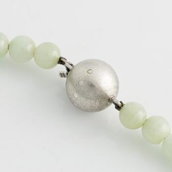 A jade necklace with silver clasp.