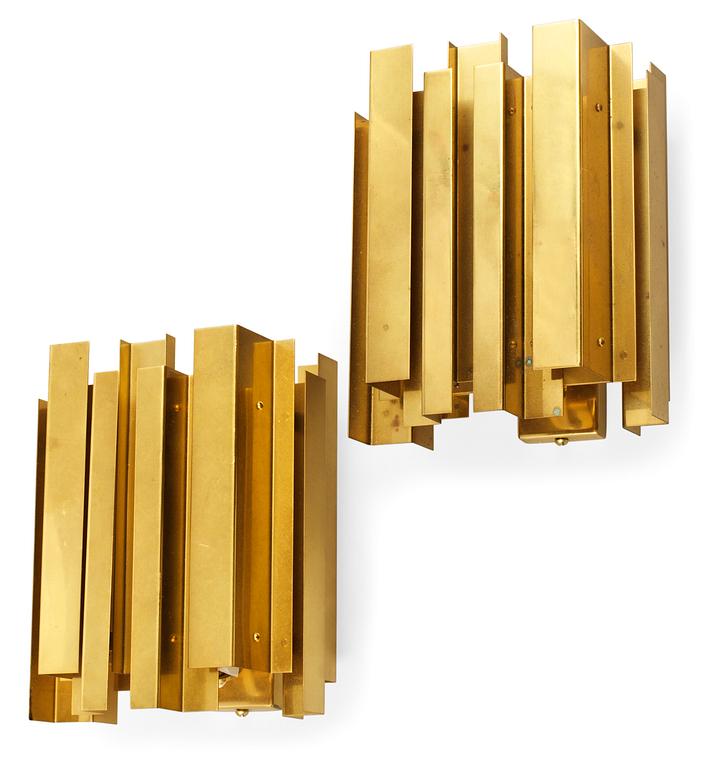 A pair of Carl-Axel Acking wall polished brass lamps probably by G Åhmans Möbelfabrik, 1960's.