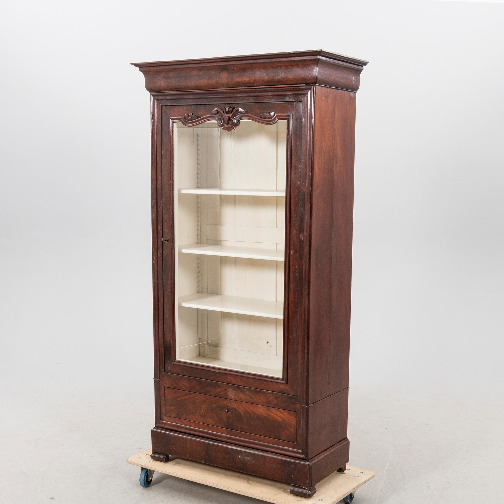 A walnut display cabinet around 1900.