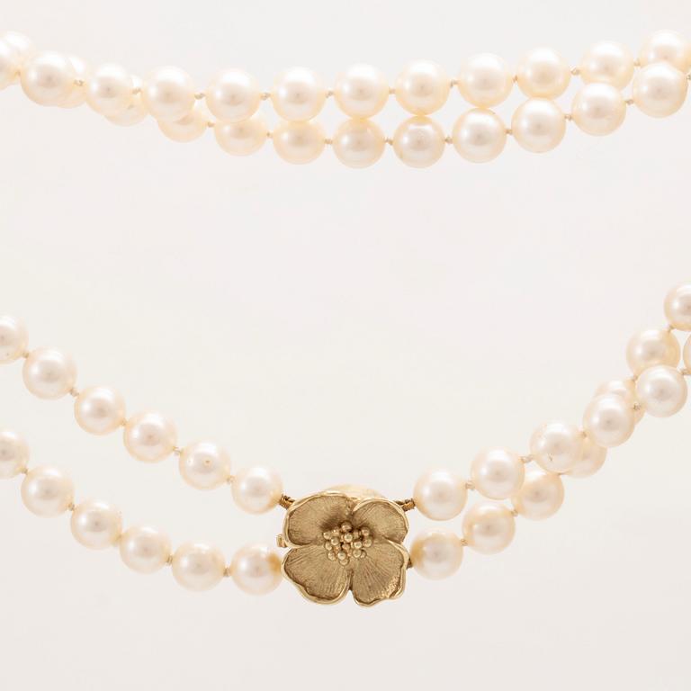 A two row cultured pearl necklace with 14K gold clasp.