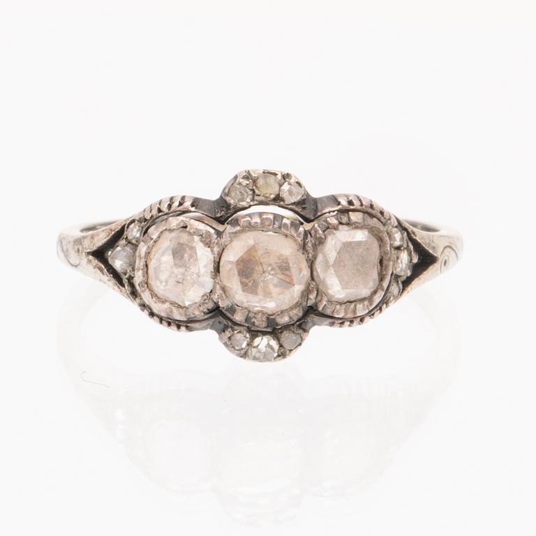An 18K white gold ring set with rose cut diamonds.