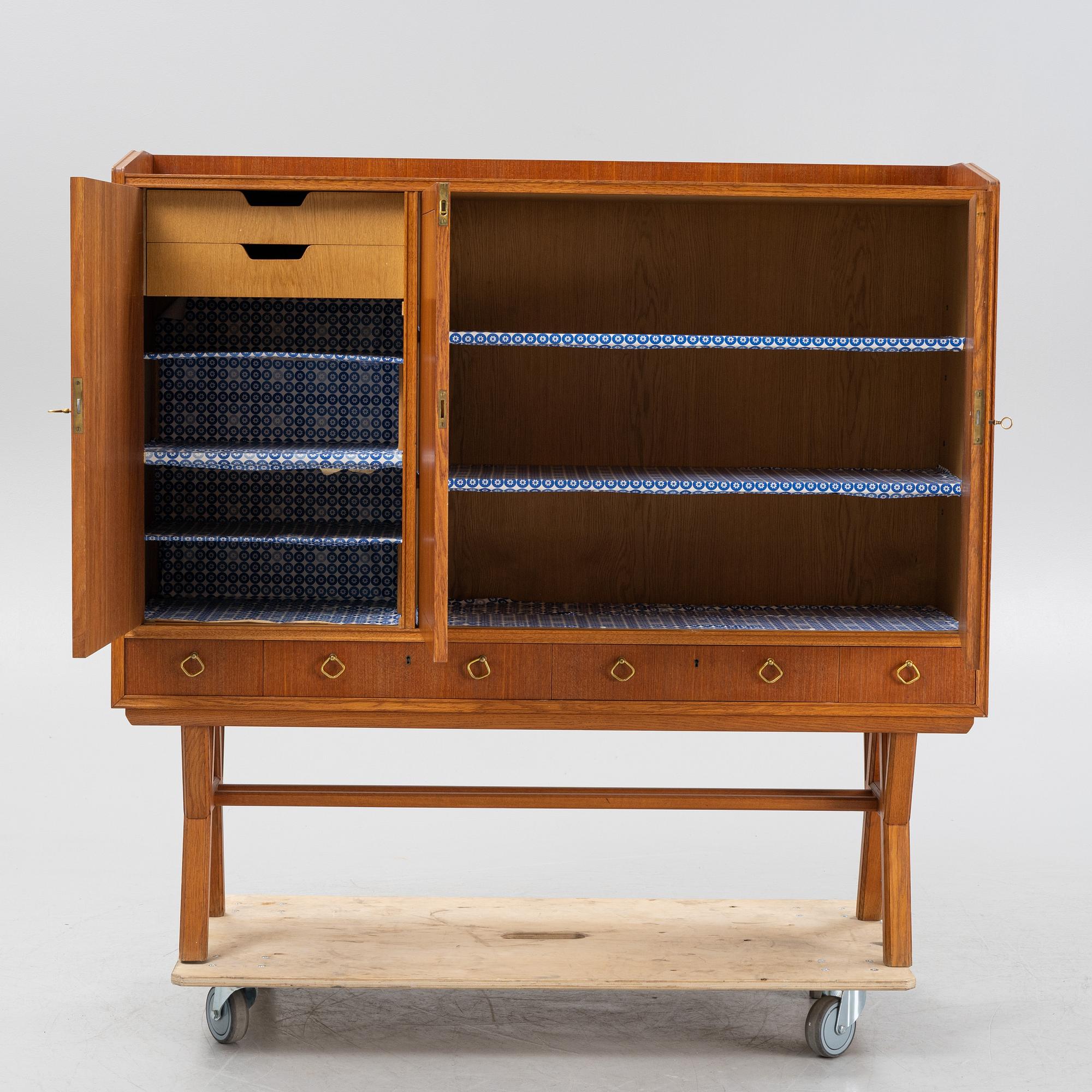 A teak-veneered mid 20th century sideboard.