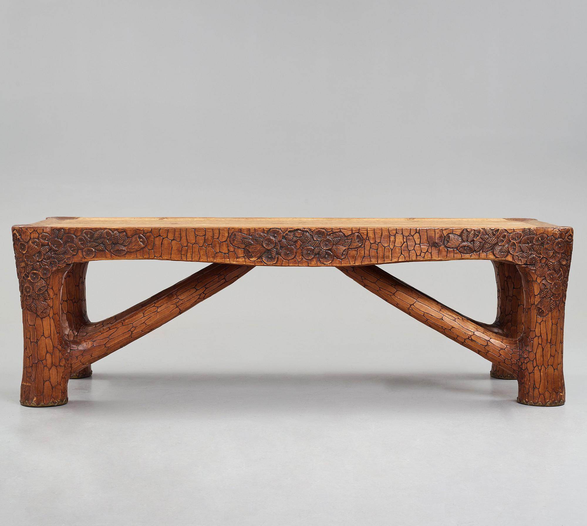 Gustaf Fjaestad, an Art Nouveau carved pine table, Arvika Sweden 1914, a double to the table in the Thiel Collection,