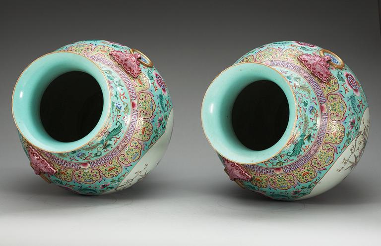 A large pair of turquoise ground famille rose vases, early 20th Century with Qianlongs sealmark.