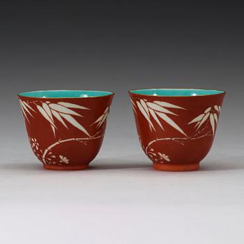 A pair of coral-red ground "Bamboo" cups, Qing dynasty, 19th Century.