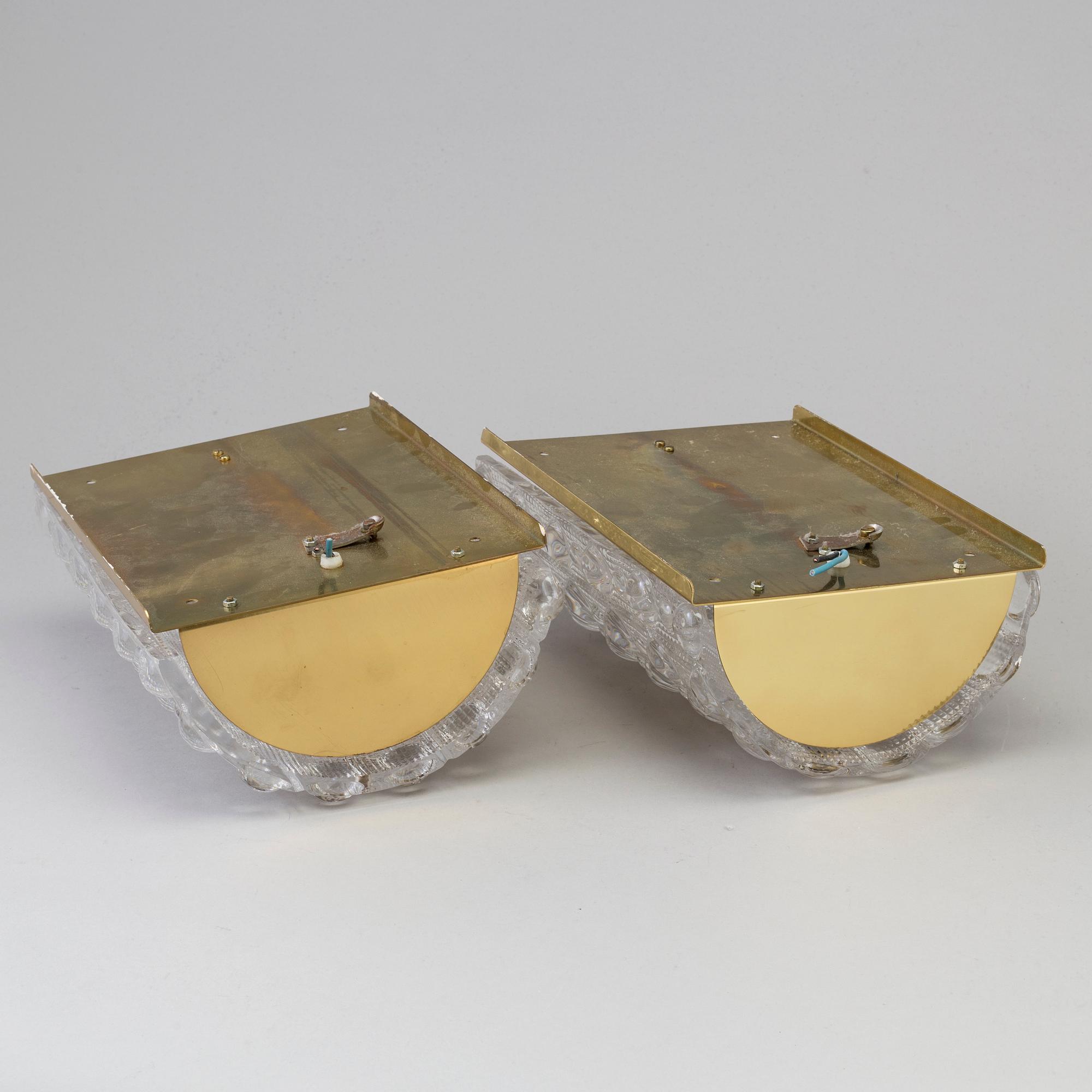 CARL FAGERLUND, a pair of brass and glass wall lights, Orrefors.