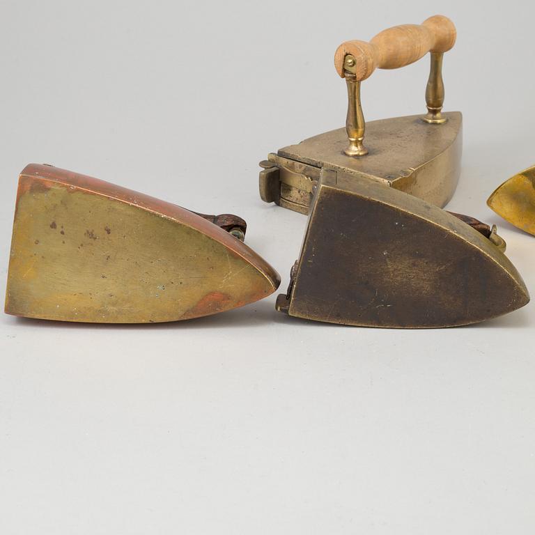 FOUR 19TH CENTURY BRASS IRONS.