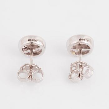 A pair of 14K gold earrings set with round brilliant-cut diamonds.