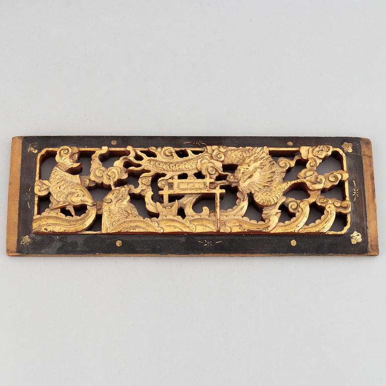 A Chinese gilt and wooden panel depicting Dragon gate, Qing dynasty, late 19th/early 20th century.