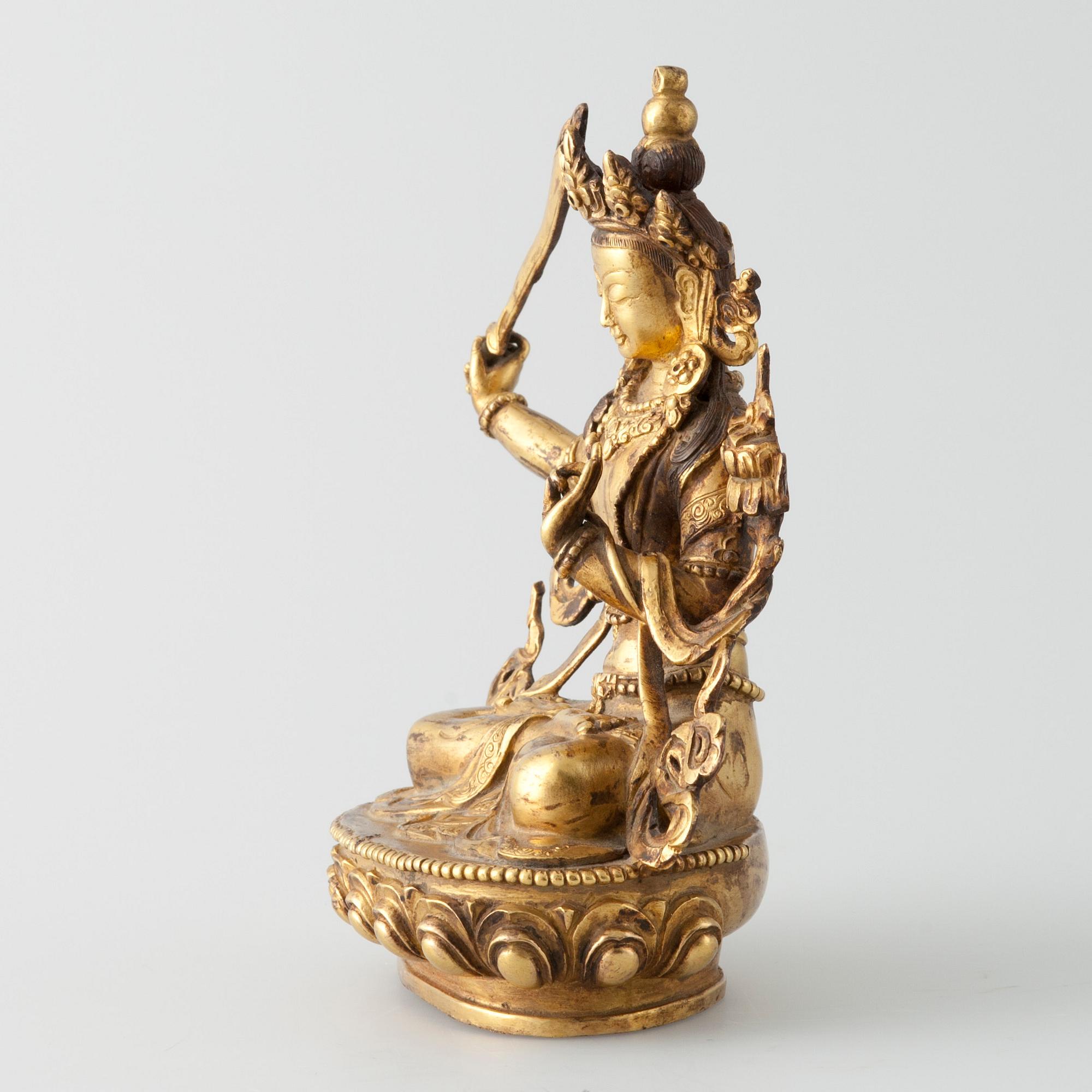 SKULPTUR, "Manjushri", förgylld metallegering, Tibet 1900-talets mitt.