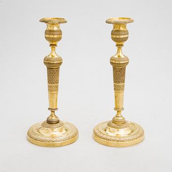 A pair of Empire bronze candlesticks from the first half of the 19th century.