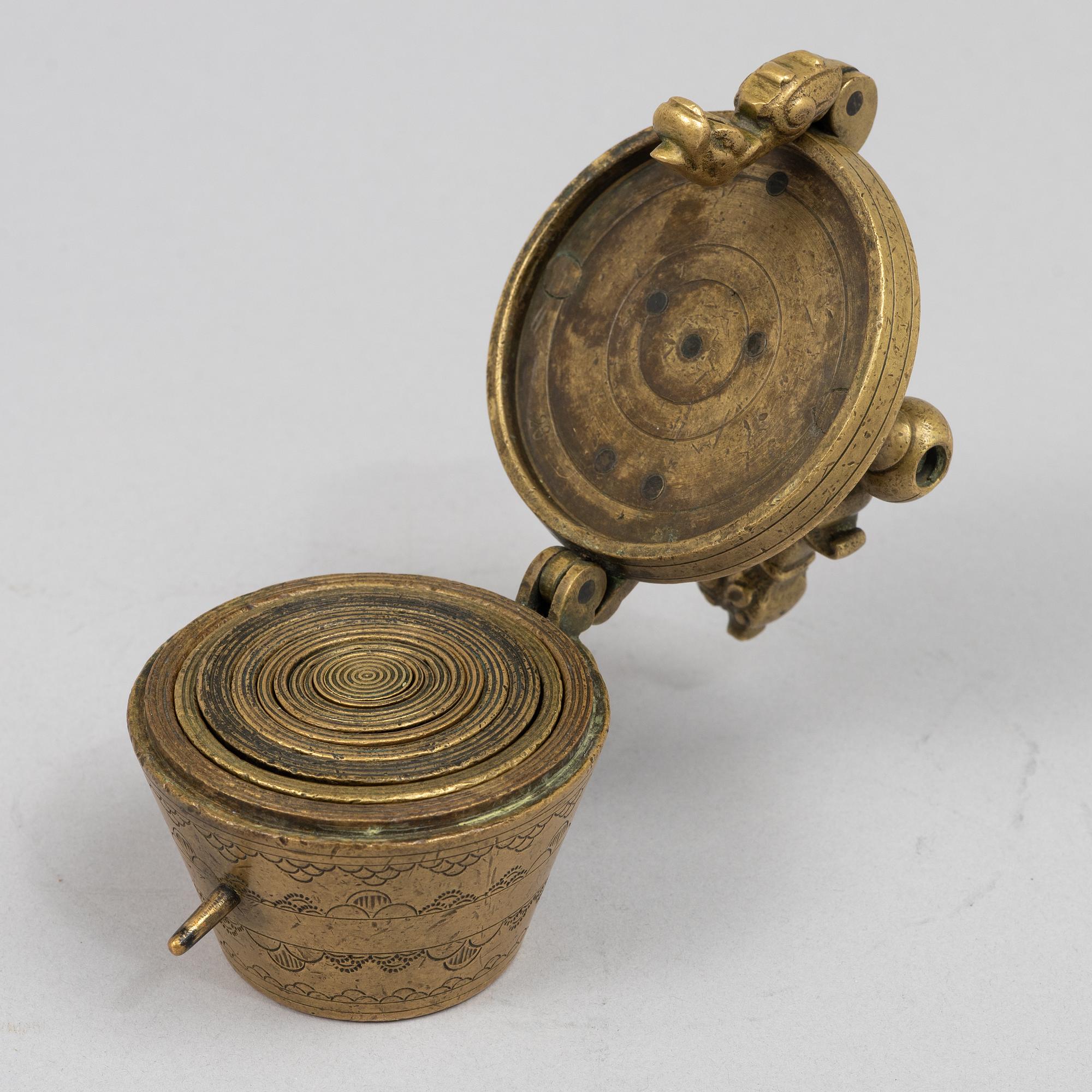 A brass weight set, late 19th century.