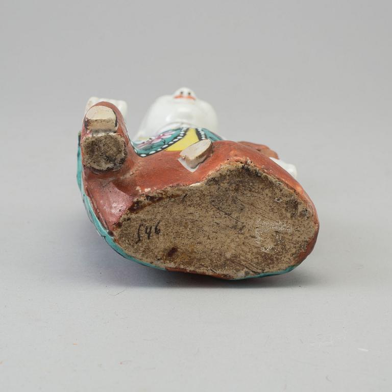 A porcelain figure of a laughing boy, Qing dynasty, 19th Century.