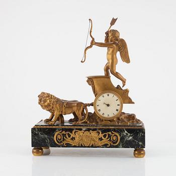 An Empire-style gilt-bronze and verde antico 'Au char de l'Amour' figural mantel clock, late 19th century.