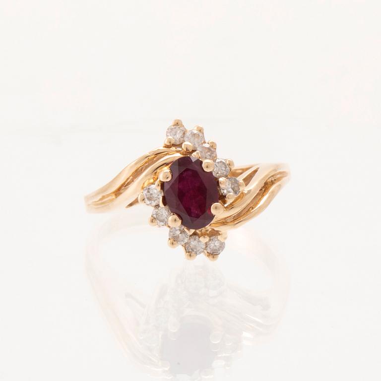 A 14K gold ring set with an oval faceted synthetic ruby and round brilliant-cut diamonds.