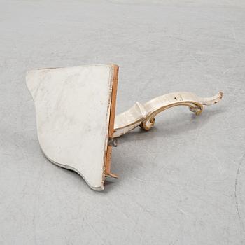 A samll console table for a corner with a wooden top.