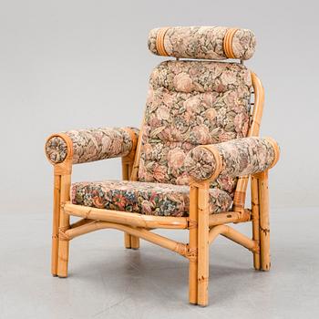 A set of two garden sofas, an armchair and a glass table, later part of the 20th Century.