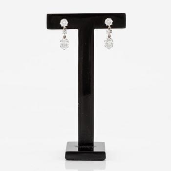 A pair earrings in 18K white gold set with round and oval brilliant-cut diamonds.
