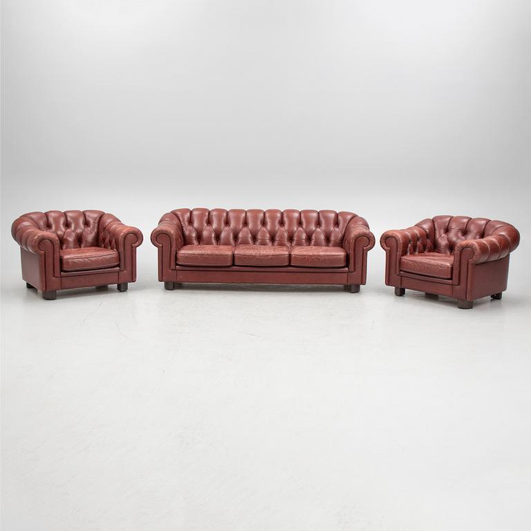 A sofa and a pair of armchairs, 'Chesterfield model', late 20th Century.