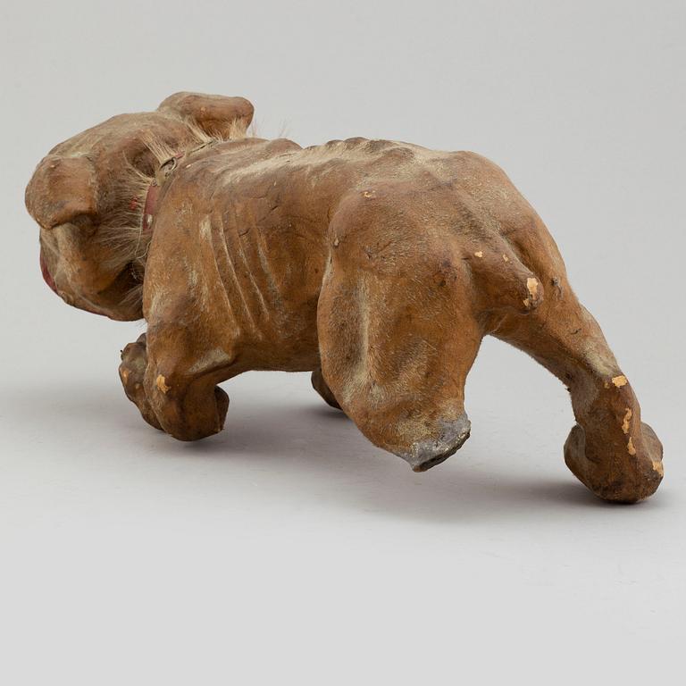 A circa 1900 papier maché toy dog.