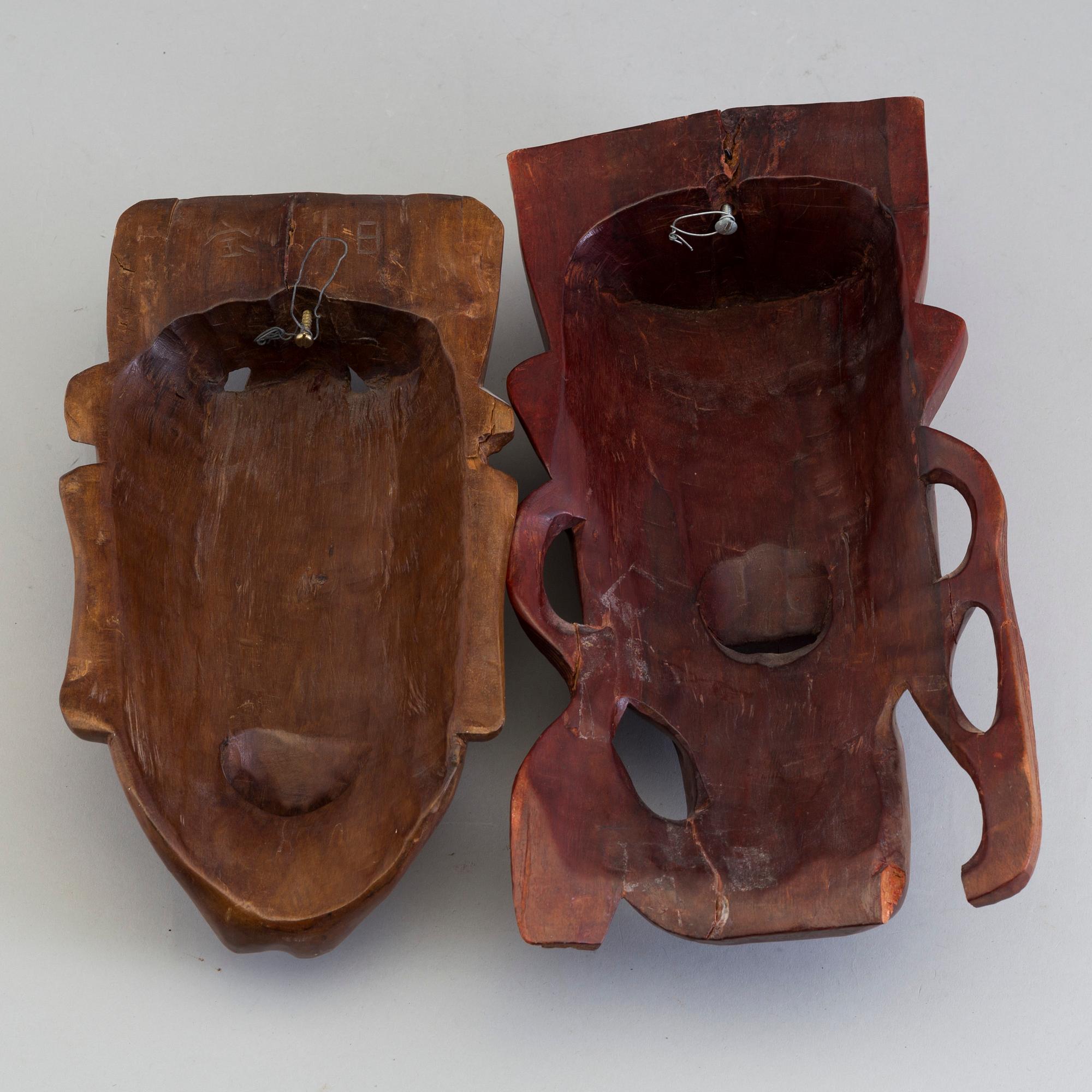 Two wooden south east asian masks, 20th century.