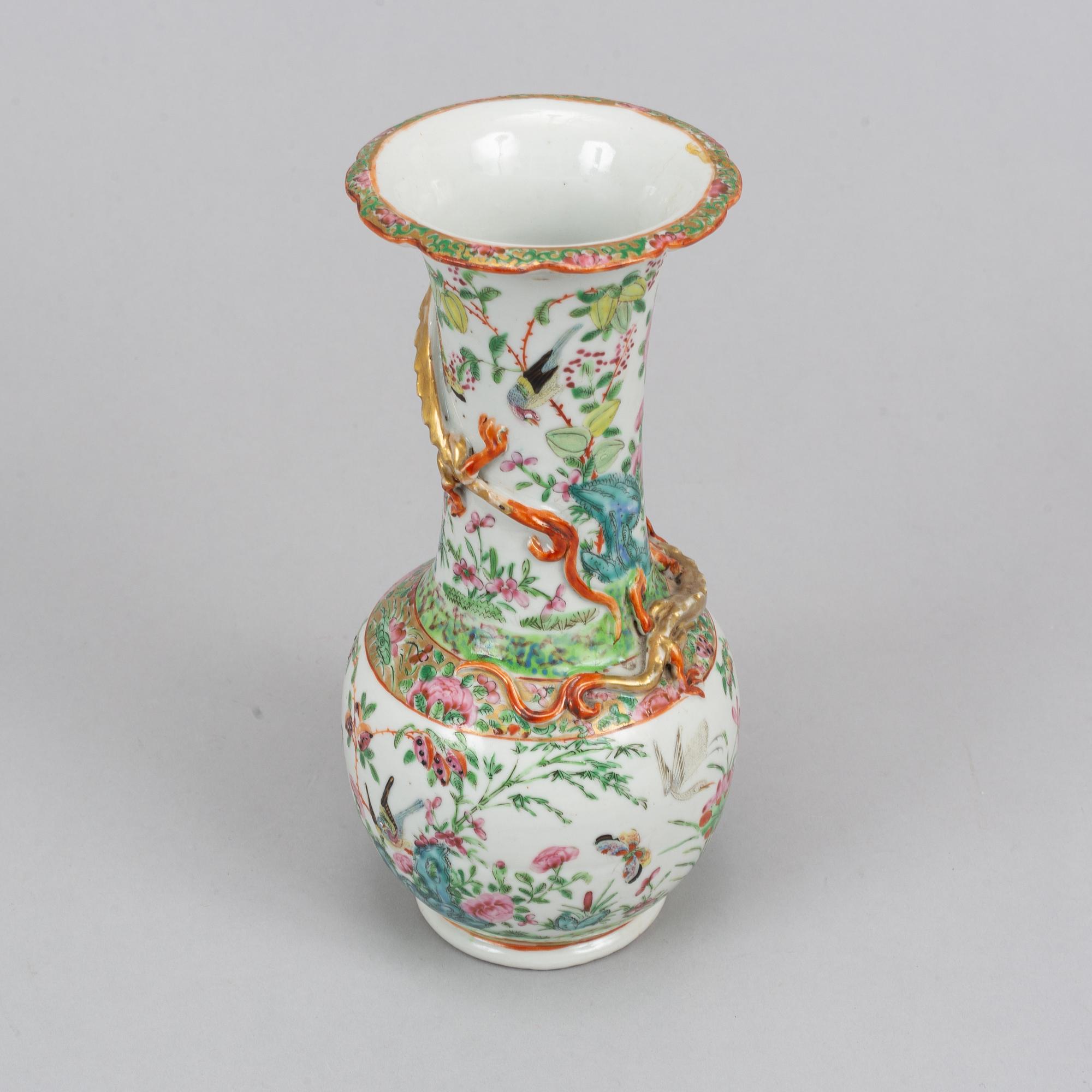 A pair of famille rose Canton table lamps and a vase, Qing dynasty, 19th Century.