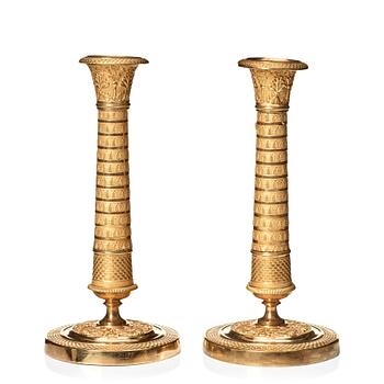 125. A pair of Empire candlesticks.