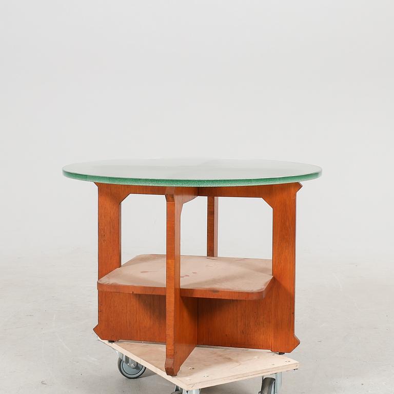 A 1940s wood and glass coffee table.