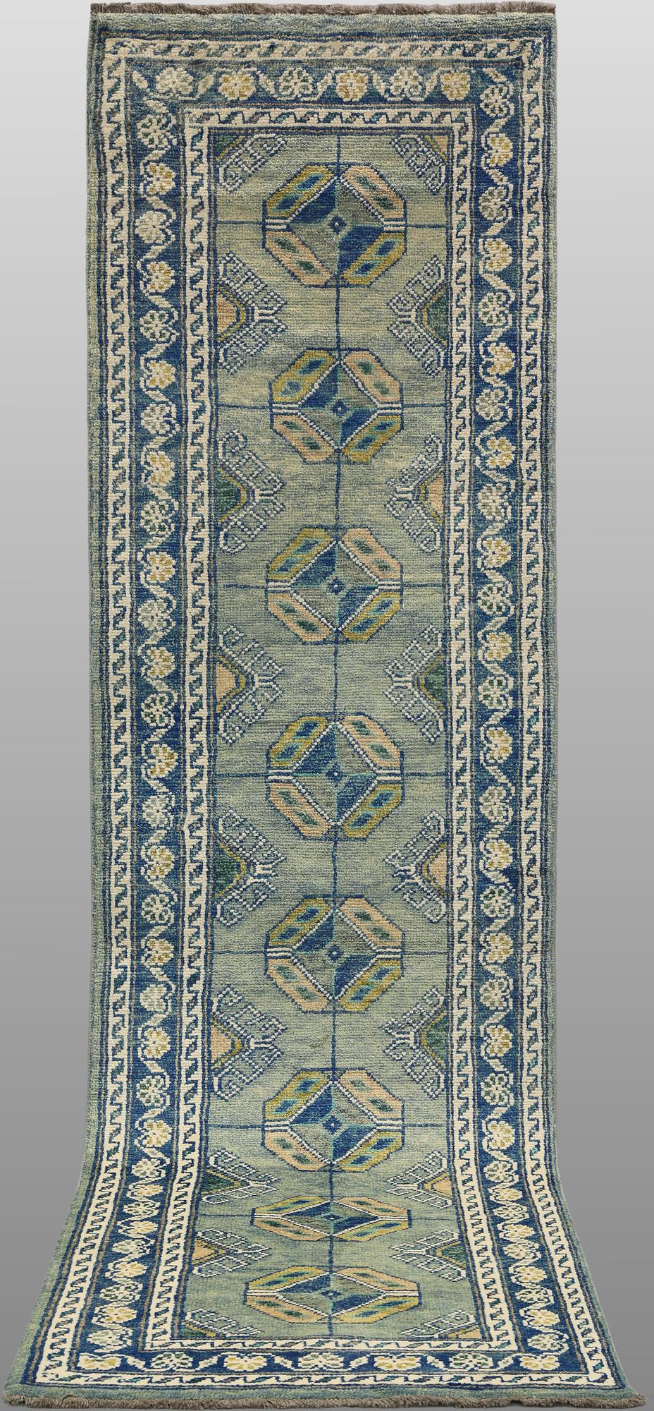 An Oriental runner, c. 296 x 77 cm.