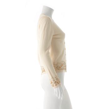 ESCADA, a creme colored wool and cashmere blend cardigan with sequin embellishment.