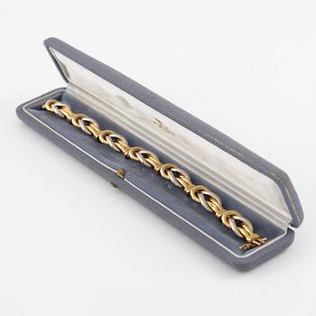 A bracelet in 18K gold and white gold.