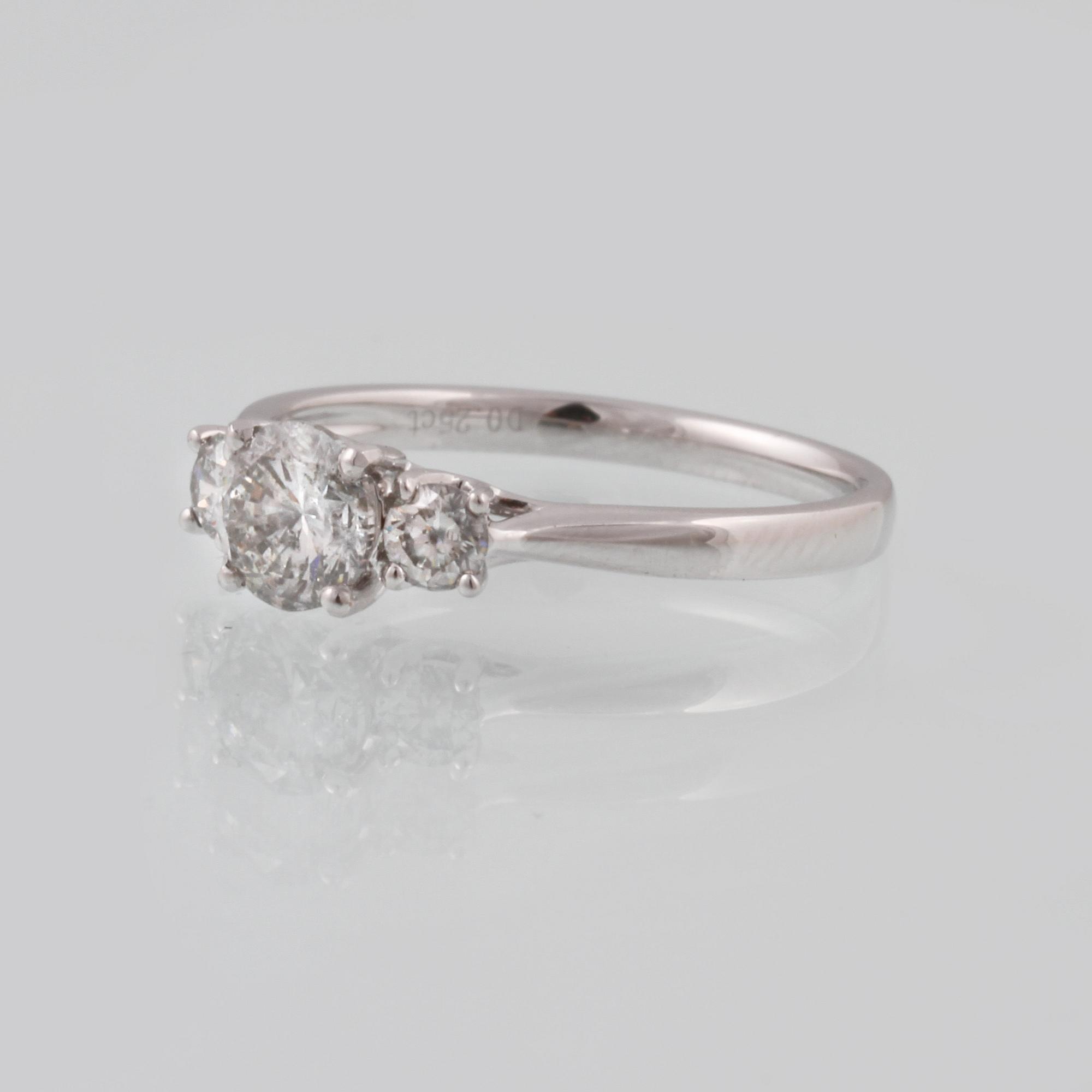 RING, 18K vitguld med en briljantslipad diamanter ca 0.70 samt 2 briljantsliapde diamanter ca 0.23 ct. Vikt 2,5 gram.