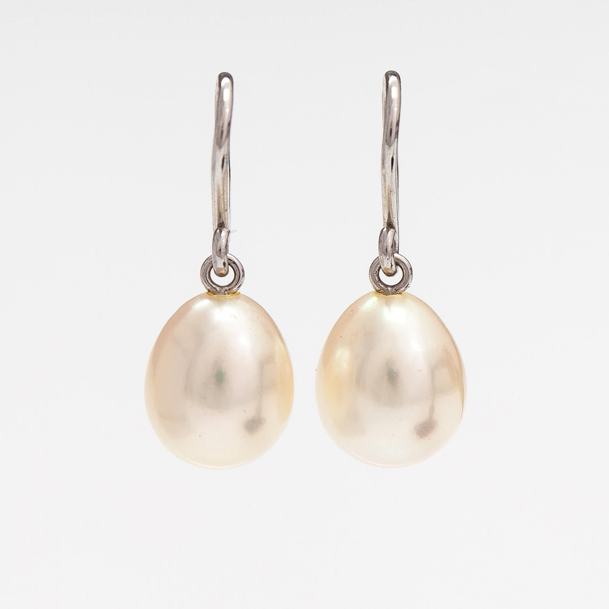 A pair of 18K white gold earrings with drop shaped cultured pearls. Schoeffel.