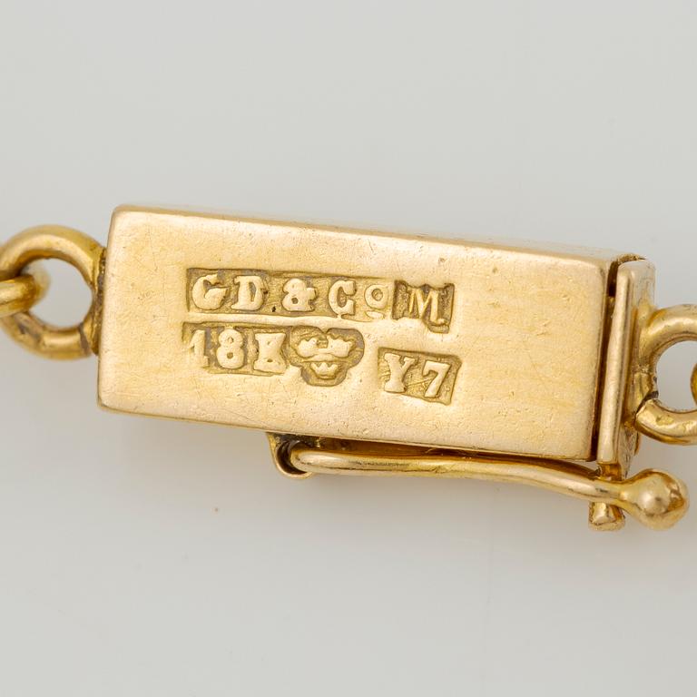 Bracelet in 14K gold with various minerals and scarab-shaped charms.