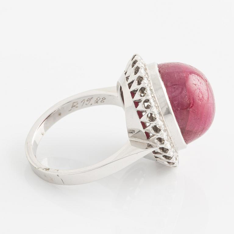 Ring, 18K white gold with cabochon-cut ruby and brilliant-cut diamonds.