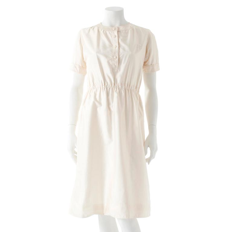 COURRÈGES, a creme colored silk dress.