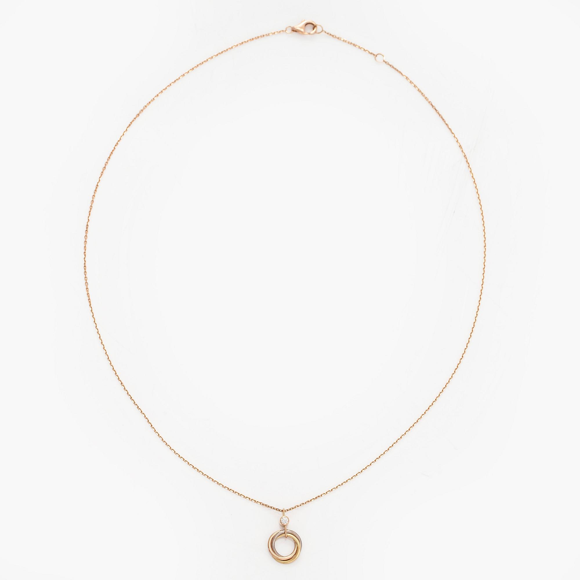 Cartier, an 18K gold 'Trinity Pendant' necklace with a brilliant-cut diamond.