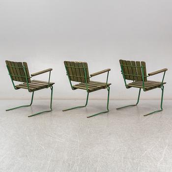 Three Arbrå stålmöbler and Grythyttan garden armchairs and a table, mid 20th century.