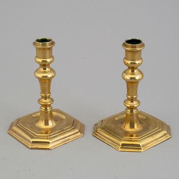 A pair of 18/19th century brass candlesticks.