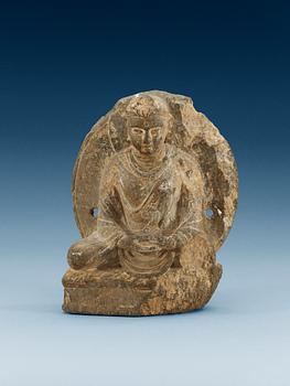 1477. A carved stone figure of a sitting Buddha, presumably Ghandara.