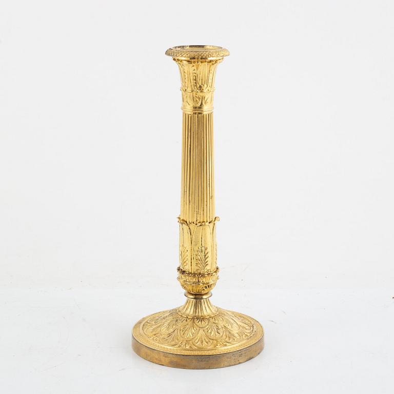 A French Empire gilt-bronze candlestick, early 19th century,