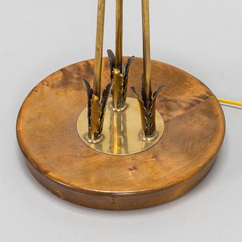 A three-arm floor lamp in brass, mid 20th century.
