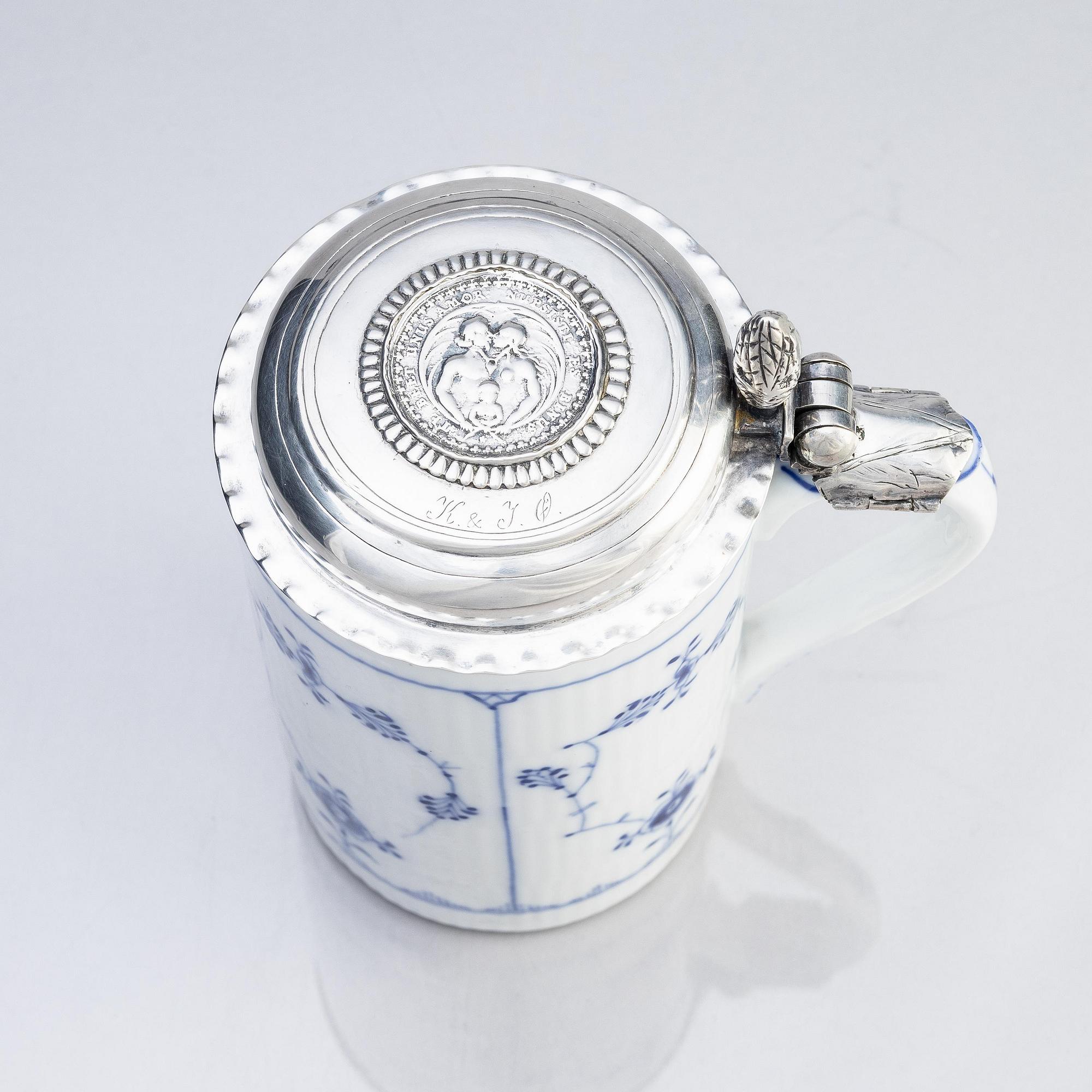 A porcelain beer mug with silver fittings and cover, Dermany/Denmark, 18th century.