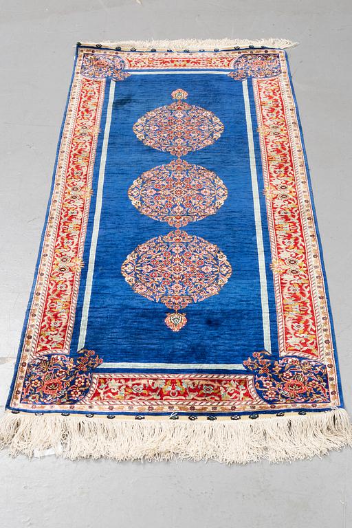 A rug, silk Hereke, ca 143 x 63,5 cm.
